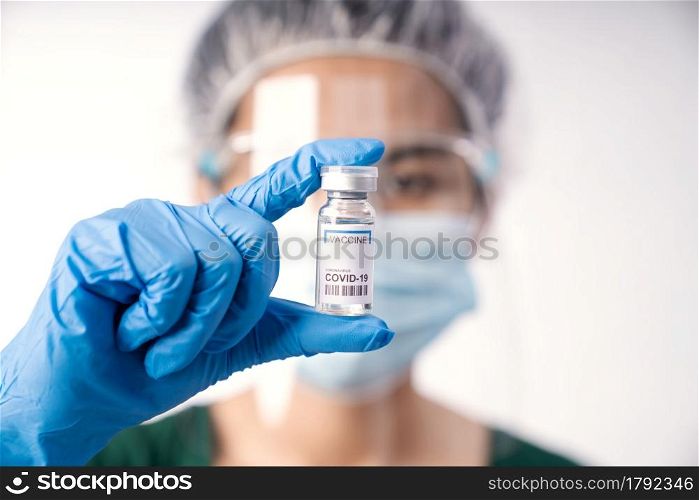 close-up scientist holding vaccine coronavirus in lap