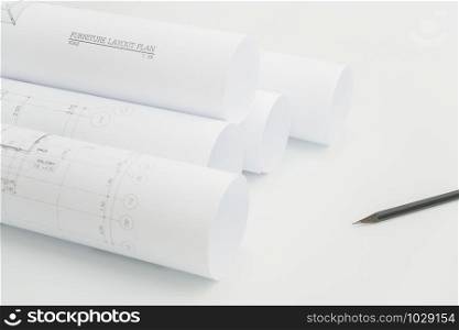 Close up scroll of architectural drawing and pencil on architect&rsquo;s working table