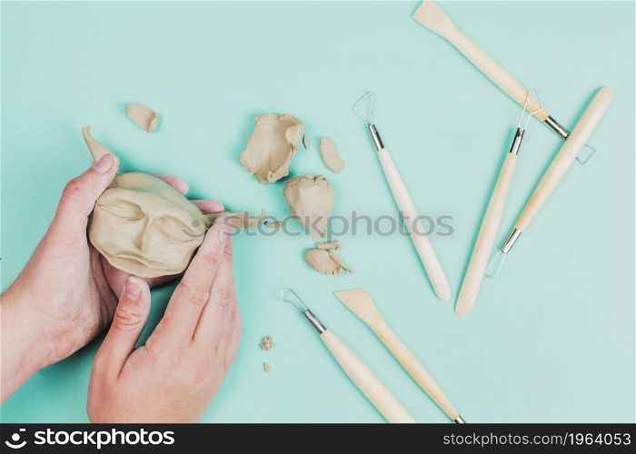 close up sculptor artist creating sculpture face with clay colored background. High resolution photo. close up sculptor artist creating sculpture face with clay colored background. High quality photo