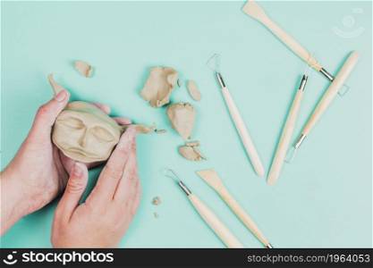 close up sculptor artist creating sculpture face with clay colored background. High resolution photo. close up sculptor artist creating sculpture face with clay colored background. High quality photo