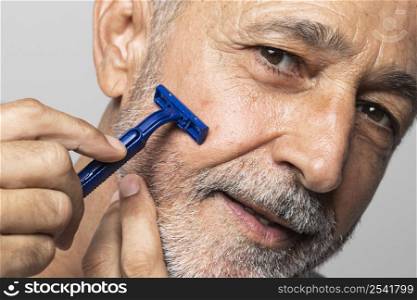 close up senior man shaving