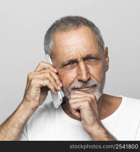 close up senior man talking phone