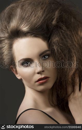 close-up shoot of beautiful brunette girl with cute make-up and volume fashion hair-style