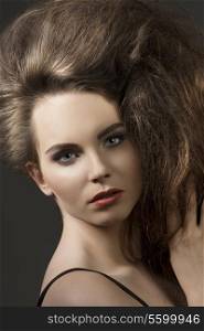 close-up shoot of beautiful brunette girl with cute make-up and volume fashion hair-style