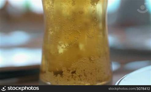 Close-up shot of a glass with cold light beer and bubbles. Refreshing alcohol beverage