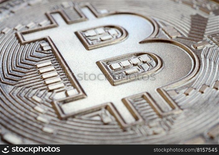 Close up shot of a physical bitcoin with a shiny relief surface made of chocolate. Abstract image of the crypto currency in an edible form