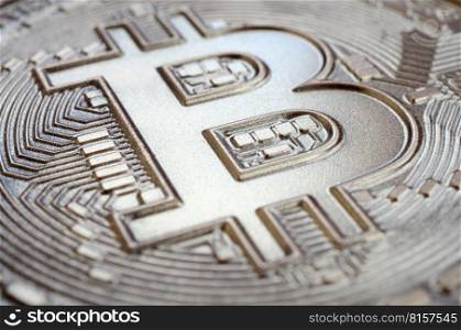 Close up shot of a physical bitcoin with a shiny relief surface made of chocolate. Abstract image of the crypto currency in an edible form