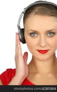 Close-up shot of a woman listening to music