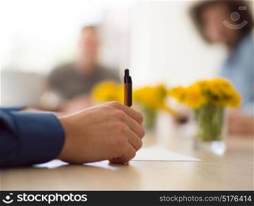 close up shot of Business man hand holding pen writing on papers at seminar or signing contract making a deal