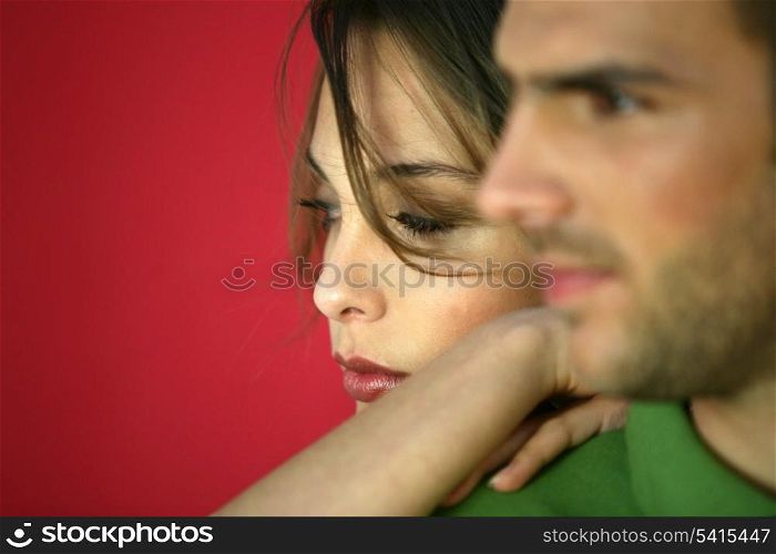 Close-up shot of couple on red background