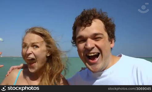 Close-up shot of crazy loving couple screaming together and kissing