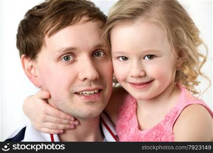 Close-up shot of dad with dear little daughter. Girl embracing fathers neck. Happy family portrait. Portrait of happy daughter with dear father