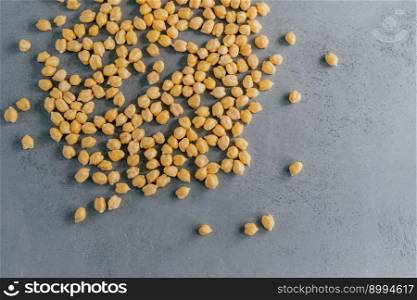 Close up shot of dry chickpeas on grey background. Raw vegetarian food. Healthy dieting concept. Natural vegan food. Clean garbanzo