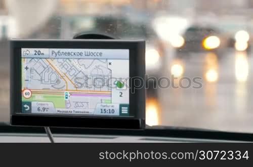 Close-up shot of GPS device showing a turning to Michurinsky Prospekt and driver following it. Easy traveling in metropolis with GPS navigation