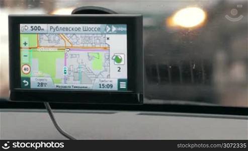 Close-up shot of GPS nagivagion device showing next turning. Easy driving in the city