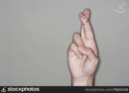 Close up shot of man hugging girlfriend finger drawing