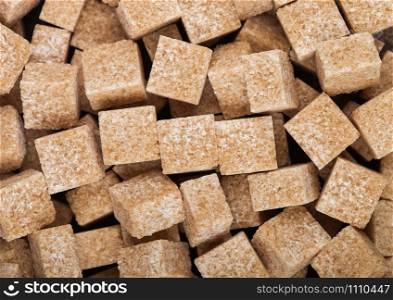 Close-Up shot of natural brown sugar cubes on white. Top view