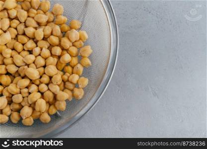 Close up shot of raw chickpeas in sieve. Healthy food. Roasted garbanzo. Eco vegetarian dish concept. Vegatable source of protein.