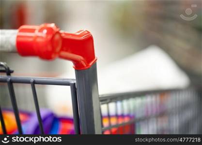 Close-up shot of shopping cart with some goods there. Going shopping
