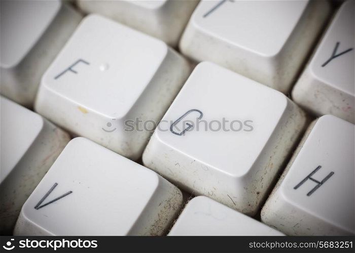 Close up shot of the keys ona white but dirty keyboard