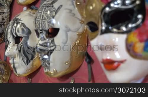 Close-up shot of three artistic vintage Venetian masks exposed in the shop. Handmade carnival accessories. Shot with changing focus