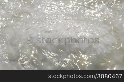 Close-up shot of water washing crystal salt formation of Dead Sea. It sparkling in the sun