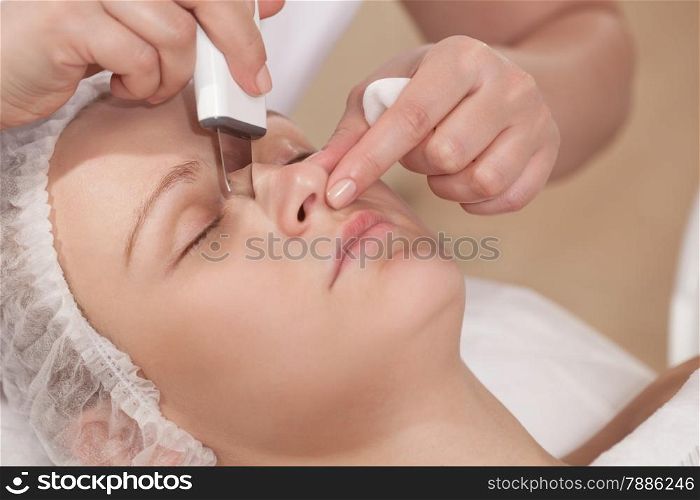 Close-up shot of woman getting ultrasonic cleaning of a nose at beauty treatment salon