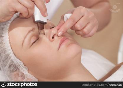 Close-up shot of woman getting ultrasonic cleaning of a nose at beauty treatment salon