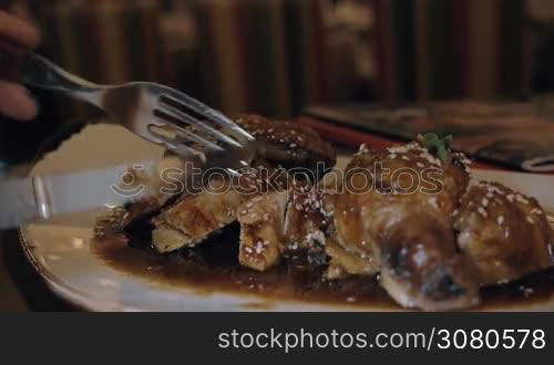 Close-up shot of woman having restaurant dish with chicken cooked in Asian style