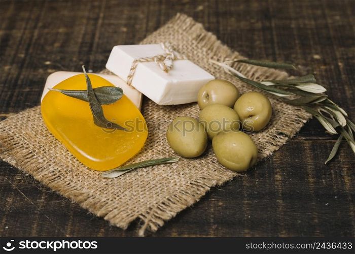 close up shot olives with soap bars sackcloth