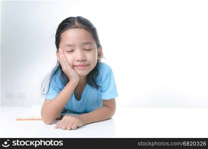 Close up shot portrait of smile Asian little girl close her eyes and sitting chin with happiness, with copy space