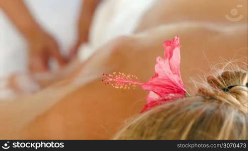 Close-up shot with changing focus of a woman getting finger massage at beauty spa