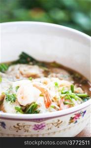 Close up shrimp topped on spicy noodles soup