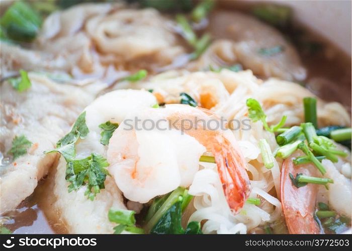 Close up shrimp topped on thai style spicy noodles soup
