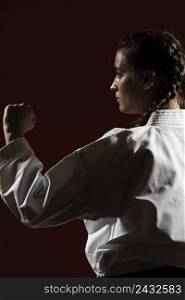 close up sideways woman white karate uniform
