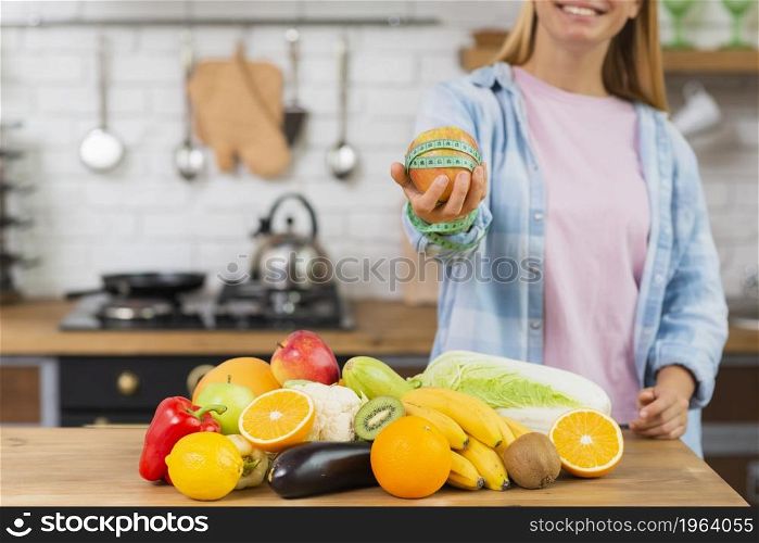 close up smiley girl holding up apple. High resolution photo. close up smiley girl holding up apple. High quality photo