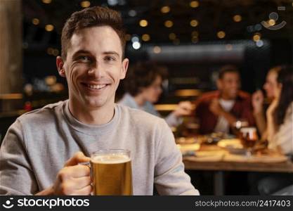 close up smiley man holding beer mug