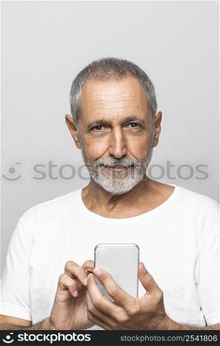 close up smiley man holding smartphone