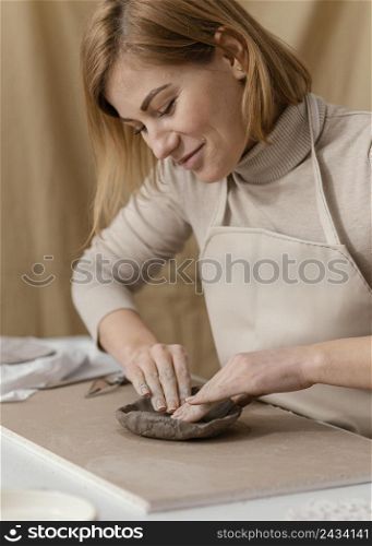 close up smiley woman doing pottery