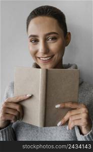 close up smiley woman holding notebook