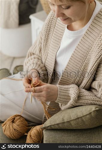 close up smiley woman knitting