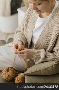 close up smiley woman knitting