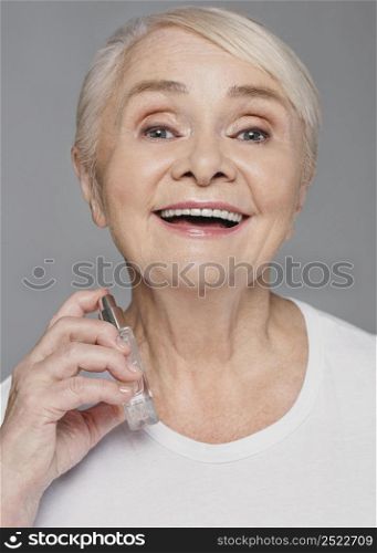 close up smiley woman using perfume