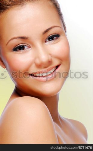 Close-up smiling face of young adult beautiful woman