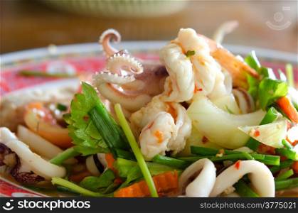 close up spicy mix salad with seafood ,sausage and vegetable