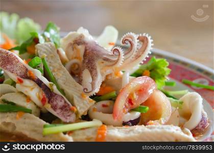 close up spicy mix salad with squid ,sausage and vegetable