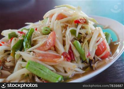 close up spicy papaya salad with mix vegetable on plate , spicy salad