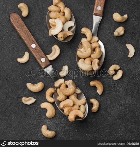 close up spoons filled with healthy raw cashew nuts. High resolution photo. close up spoons filled with healthy raw cashew nuts. High quality photo