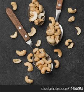 close up spoons filled with healthy raw cashew nuts. High resolution photo. close up spoons filled with healthy raw cashew nuts. High quality photo
