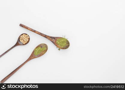 close up spoons with matcha tea powder